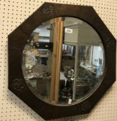A Liberty style beaten copper octagonal wall mirror with central bevel edge plate,
