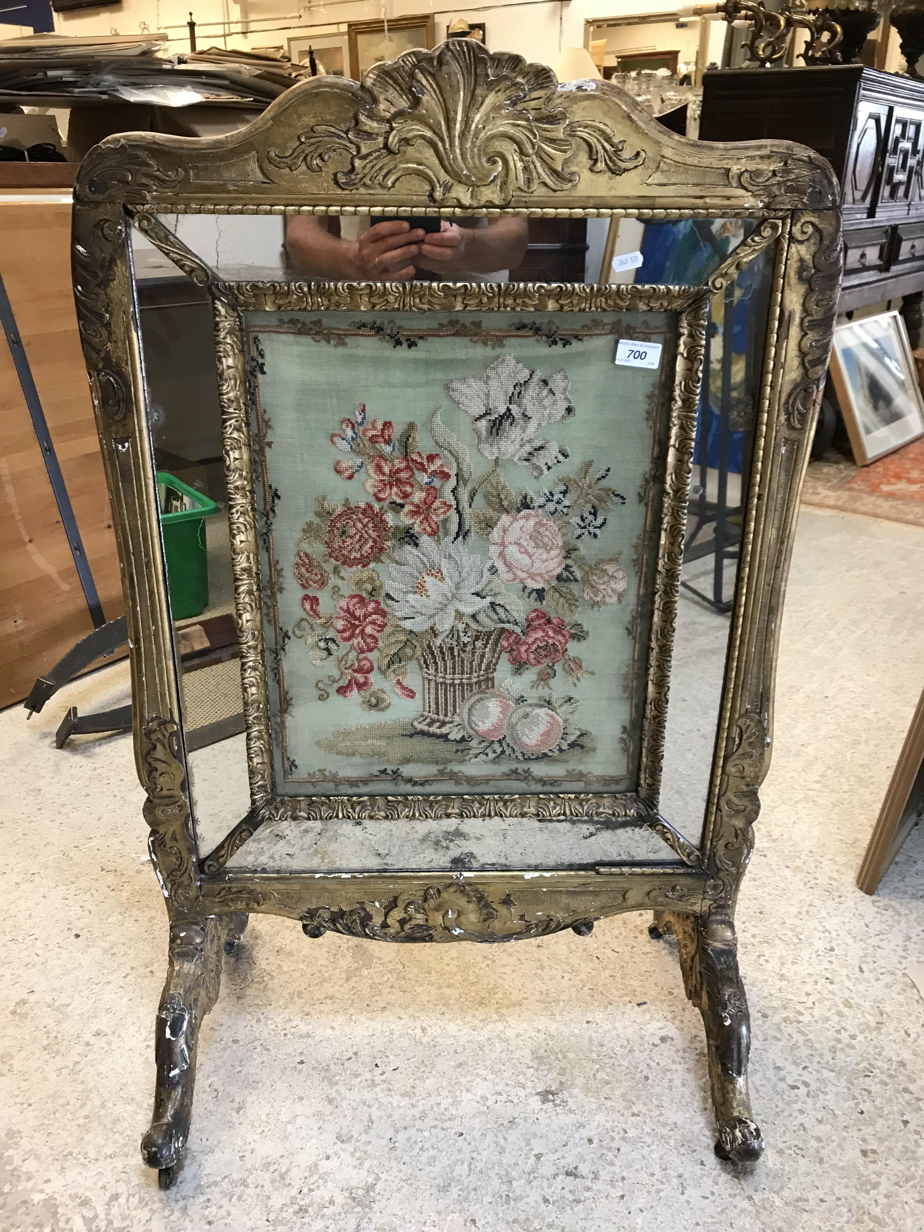 An early 19th Century carved giltwood and gesso framed fire screen,