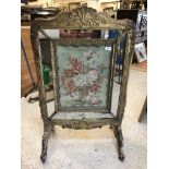 An early 19th Century carved giltwood and gesso framed fire screen,