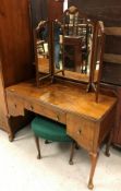 An early to mid 20th Century walnut triple wardrobe in the Georgian style,