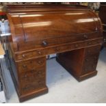 A Victorian mahogany cylinder top desk with three quarter galleried top,