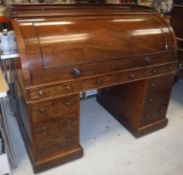 A Victorian mahogany cylinder top desk with three quarter galleried top,