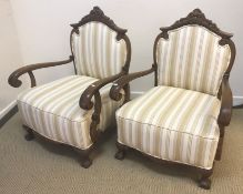 A pair of circa 1900 Continental stained beech framed open arm chairs,