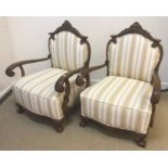 A pair of circa 1900 Continental stained beech framed open arm chairs,