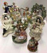 A collection of seven 19th Century Staffordshire figures of couples including "Fisherman and fish