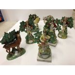A collection of seven 19th Century Staffordshire bocage figures, as a lion, a brindle deer, ram,