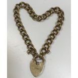 A 9 carat gold bracelet with heart-shaped locket,