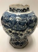 An 18th Century Dutch Delft baluster shaped octagonal vase with peacock and all-over floral