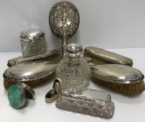 A collection of silver mounted dressing table accountrements to include a grenade scent bottle,