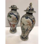 A pair of 19th Century Chinese blue and white and polychrome decorated baluster shaped vases and