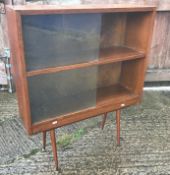 A 1960's oak display cabinet with two pairs of sliding glass doors,