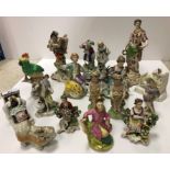 A collection of various Continental figurines including porcelain figure of "Harlequin playing a