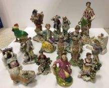 A collection of various Continental figurines including porcelain figure of "Harlequin playing a