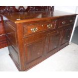 A 20th Century oak enclosed dresser in the 18th Century manner,