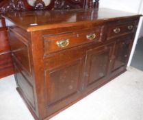 A 20th Century oak enclosed dresser in the 18th Century manner,