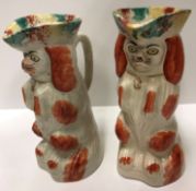 A pair of 19th Century Staffordshire "Brown and white Spaniels" as jugs in tricorn hats, 22.