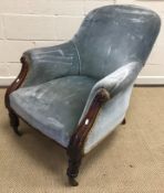 A Victorian mahogany framed upholstered armchair with acanthus carved show frame arms on turned and