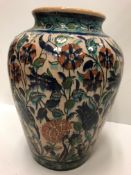 A 1930's Palestine faience glazed terracotta vase with all-over floral decoration in the Iznic