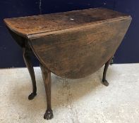 A late George III oak oval drop-leaf dining table on cabriole legs to hoof feet, 114 cm long x 96.