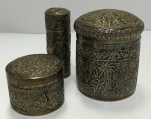 A Burmese white metal cylindrical lidded pot decorated with a band of fish above a forest scene