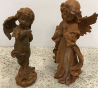 A cast iron figure of a praying angel 31 cm and a cast iron figure of a cherub with butterfly on