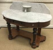 An Edwardian mahogany display table with bevel edged glazed cabinet door on a plain stand with