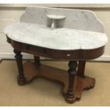 An Edwardian mahogany display table with bevel edged glazed cabinet door on a plain stand with