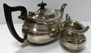 A George V silver teapot and matching milk jug with gadrooned edge (by George Nathan and Ridley