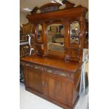 A Victorian mahogany mirror back sideboard with two drawers over two cupboard doors on a plinth