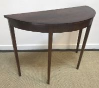 Two mahogany demi-lune side tables, one with cross-banded top on square tapered legs,