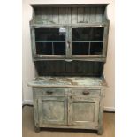 An Australian painted pine kitchen cabinet with shelf over two glazed cupboard doors enclosing