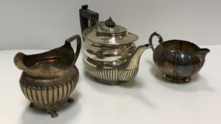 A Victorian silver teapot (London 1897) together with a Georgian silver milk jug possibly Dublin