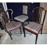 A collection of four Edwardian mahogany dining chairs with drop-in seats,