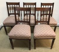 A set of five late Victorian spindle back dining chairs with upholstered seats on turned front legs