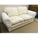 A pair of Delcor cream upholstered two seat scroll arm sofas on squat stained beech bun feet 185 cm