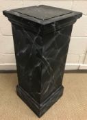A 20th Century pedestal urn stand with black marble panel within a white veined faux black marble