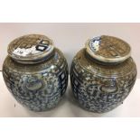 A pair of 19th Century Chinese blue and white marriage jars and covers with all over floral and