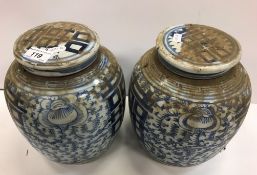 A pair of 19th Century Chinese blue and white marriage jars and covers with all over floral and