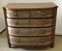An early 19th Century figured mahogany and ebony strung bow fronted chest of two short over three