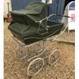 A Silver Cross pram in green CONDITION REPORTS Apron present - see images
