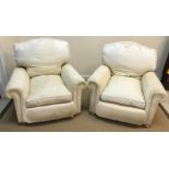 A pair of modern cream upholstered scroll arm chairs on squat bun feet,