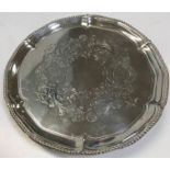 A George III silver card tray with foliate engraved centerfield within a beaded pie-crust rim,