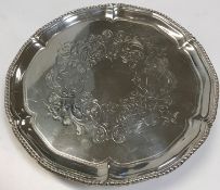 A George III silver card tray with foliate engraved centerfield within a beaded pie-crust rim,