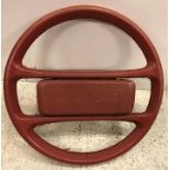 A vintage red leather covered Porsche steering wheel 38 cm diameter, a carved wooden tortoise 13.