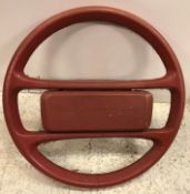 A vintage red leather covered Porsche steering wheel 38 cm diameter, a carved wooden tortoise 13.