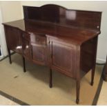 An Edwardian mahogany and inlaid breakfront sideboard,