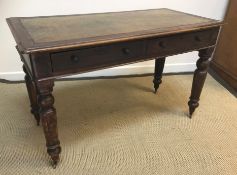 A Victorian walnut writing table,
