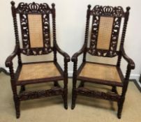 A pair of modern Chinese carved rosewood elbow chairs in the 17th Century European manner with