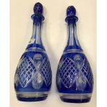 A pair of Bohemian blue overlaid cut glass pear shaped decanters and stoppers, 36.