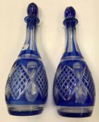 A pair of Bohemian blue overlaid cut glass pear shaped decanters and stoppers, 36.